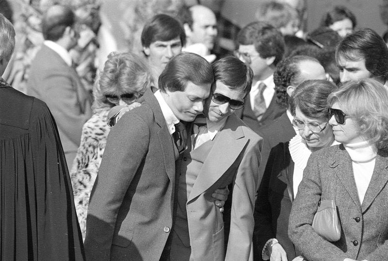 Richard Carpenter, center left, is consoled by a friend at the funeral serv...
